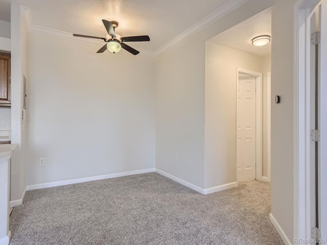 carpeted spare room featuring a textured ceiling, ceiling fan, and crown molding