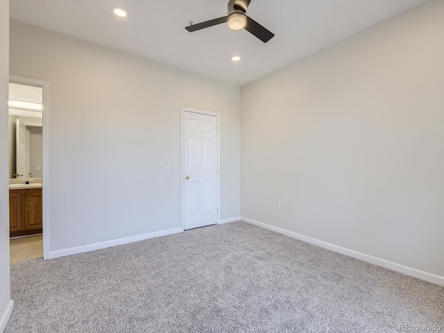 unfurnished bedroom with light carpet, connected bathroom, and ceiling fan