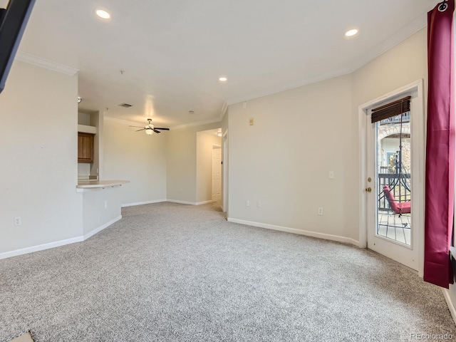 unfurnished living room featuring a wealth of natural light, crown molding, ceiling fan, and light colored carpet