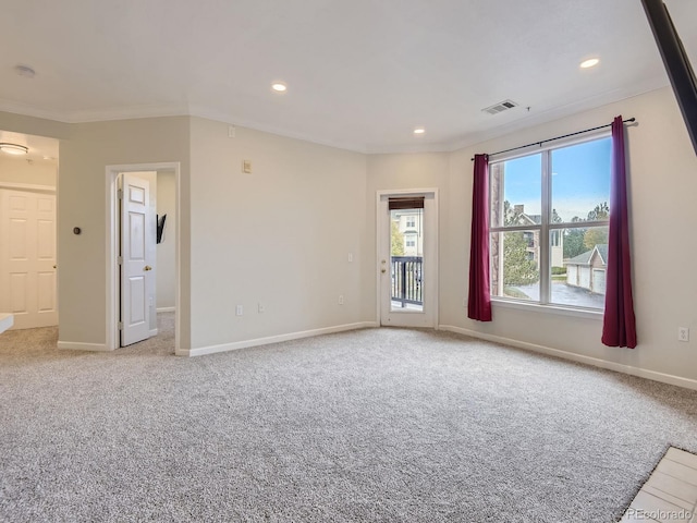 carpeted spare room with crown molding