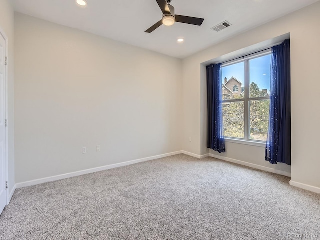 spare room with ceiling fan and carpet floors