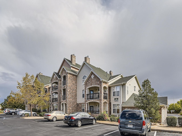 view of building exterior with uncovered parking