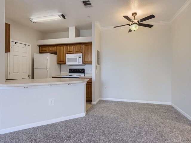 kitchen with light countertops, visible vents, brown cabinetry, white appliances, and a peninsula