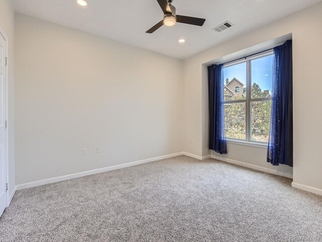 unfurnished room with recessed lighting, a ceiling fan, visible vents, baseboards, and carpet