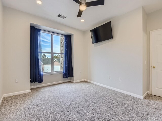 carpeted spare room featuring recessed lighting, visible vents, ceiling fan, and baseboards