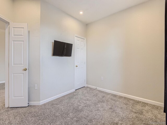 carpeted empty room with recessed lighting and baseboards