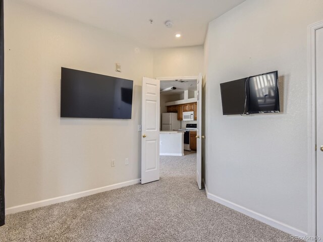 unfurnished living room with light carpet, baseboards, and recessed lighting