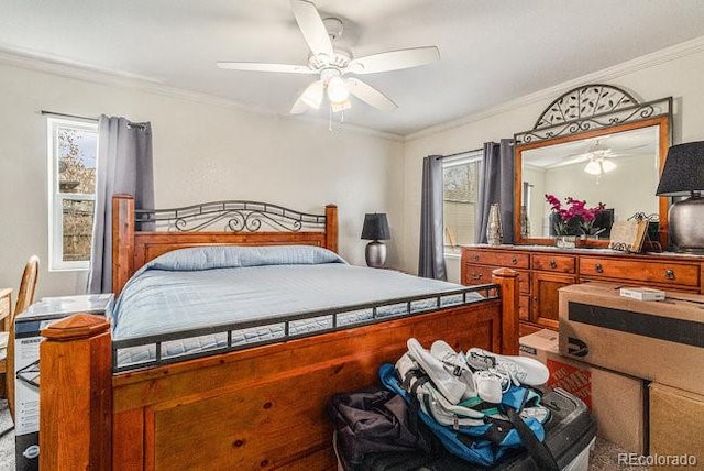 bedroom with ceiling fan and crown molding