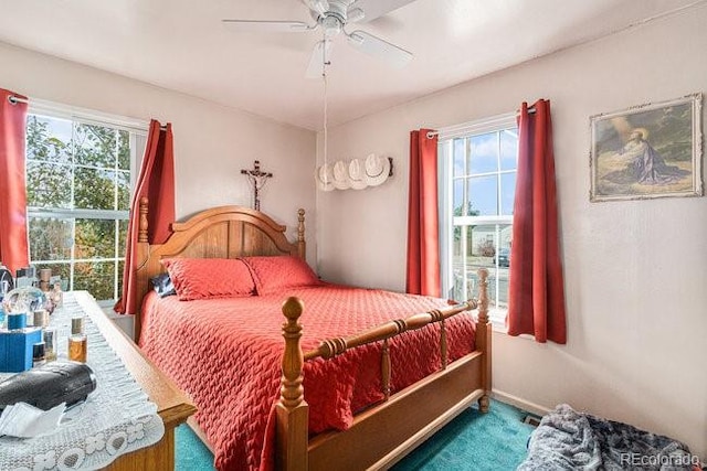 bedroom featuring multiple windows and ceiling fan