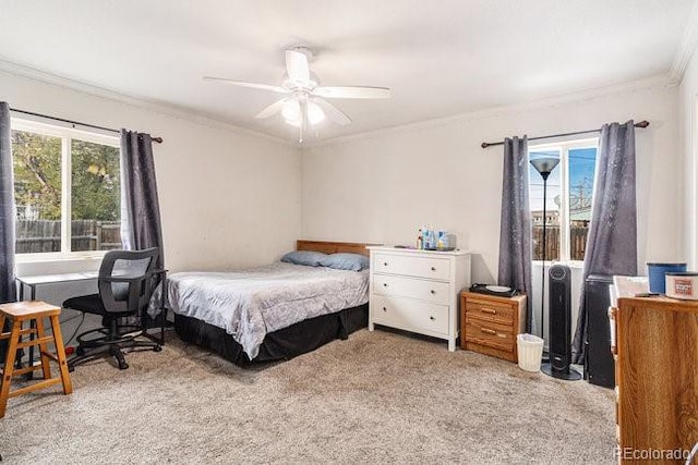 carpeted bedroom with multiple windows, crown molding, and ceiling fan