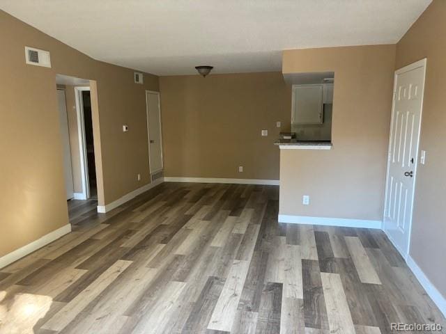 unfurnished room featuring dark wood-type flooring