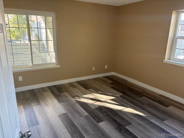 spare room featuring dark hardwood / wood-style flooring