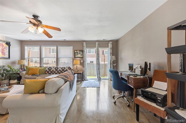 11062 Gaylord St, Northglenn, CO 80233 - living room featuring wood finished floors, ceiling fan, and a desk