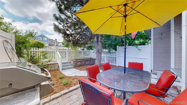 2560 Concord Cir, Lafayette, CO 80026 - fenced backyard with a grill, outdoor dining space, and a patio area