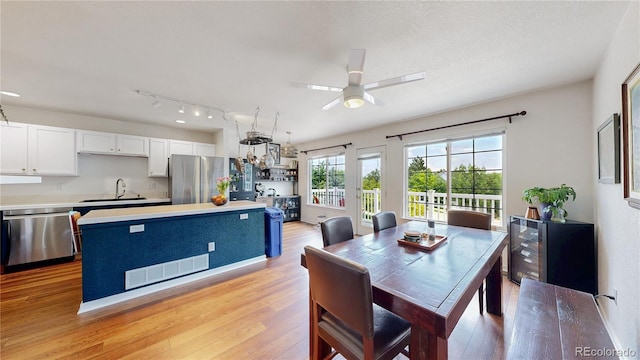 2560 Concord Cir, Lafayette, CO 80026 - dining area with light wood-style floors, ceiling fan, and wine cooler