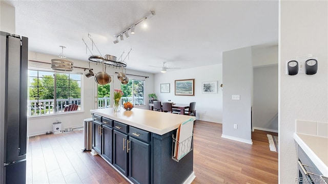 2560 Concord Cir, Lafayette, CO 80026 - kitchen featuring freestanding refrigerator, light countertops, a ceiling fan, and light wood-type flooring