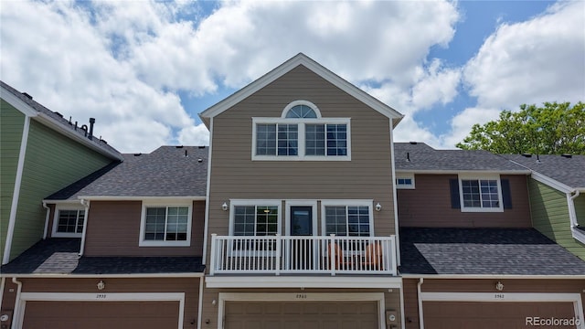 2560 Concord Cir, Lafayette, CO 80026 - view of front of home with a garage, a shingled roof, a balcony, and driveway