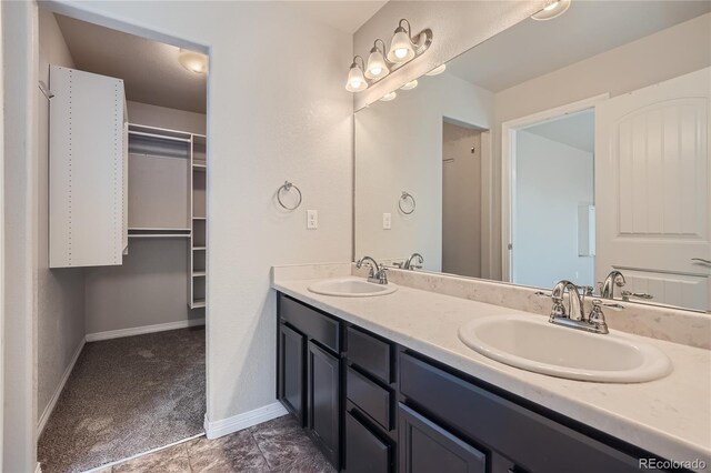 bathroom with tile patterned flooring and dual bowl vanity