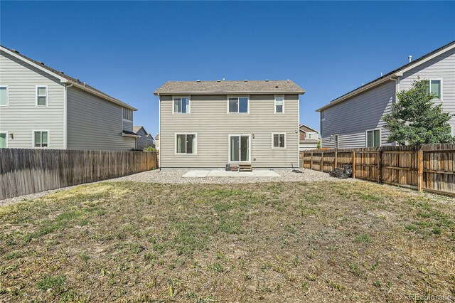 rear view of house with a patio area and a lawn