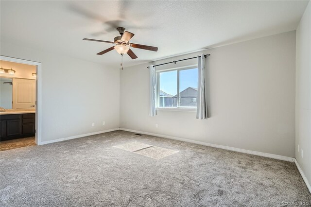 carpeted empty room featuring ceiling fan