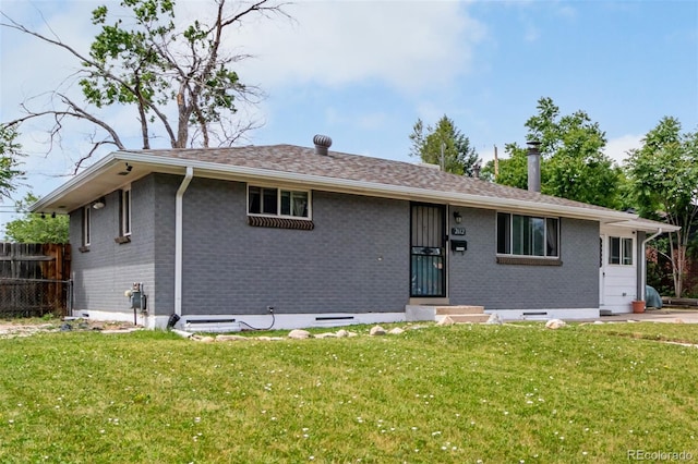 back of house with a lawn