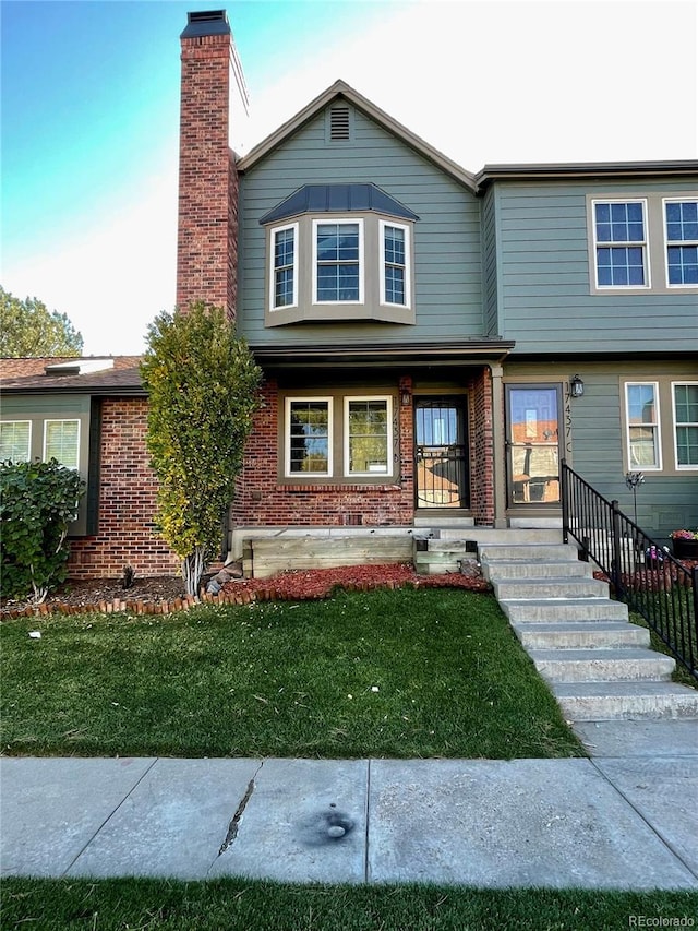 view of front of house with a front yard and covered porch