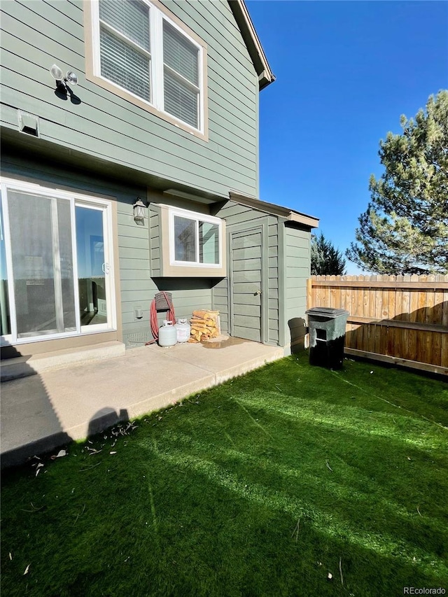 back of property featuring a yard and a patio