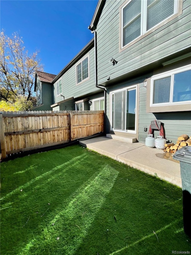 back of property featuring a yard and a patio area