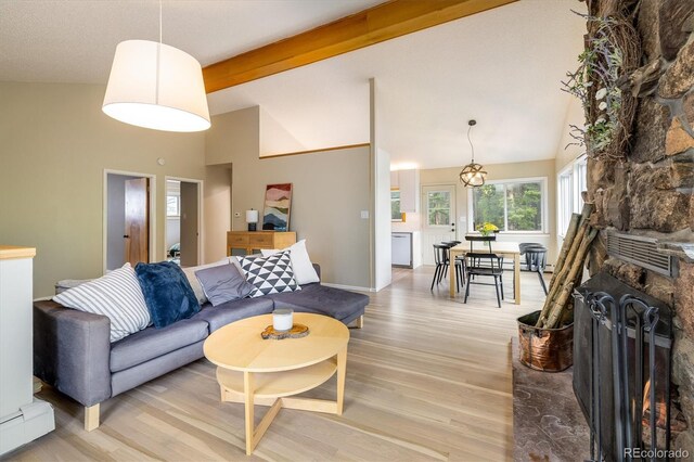 1194 Camp Eden Rd, Golden, CO 80403 - living room featuring a baseboard radiator, light wood-type flooring, beamed ceiling, high vaulted ceiling, and a fireplace