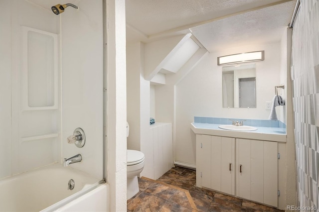 1194 Camp Eden Rd, Golden, CO 80403 - bathroom with toilet, vanity, shower / bathtub combination, stone finish flooring, and a textured ceiling