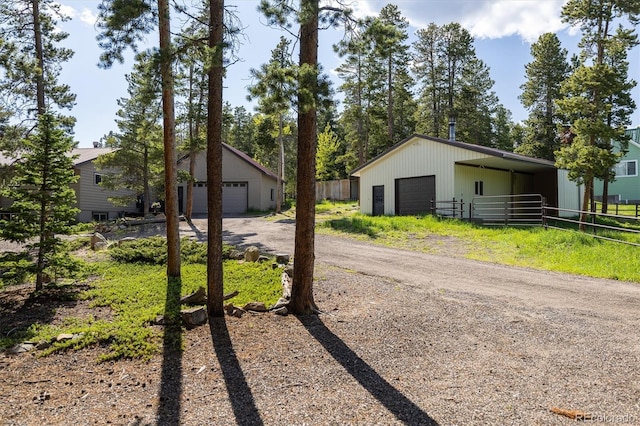 1194 Camp Eden Rd, Golden, CO 80403 - view of front of home with a detached garage, an outdoor structure, and a pole building