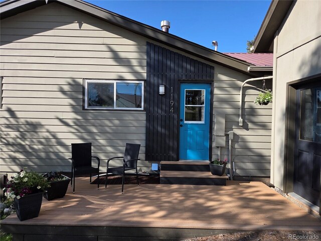 1194 Camp Eden Rd, Golden, CO 80403 - back of property with a deck and metal roof