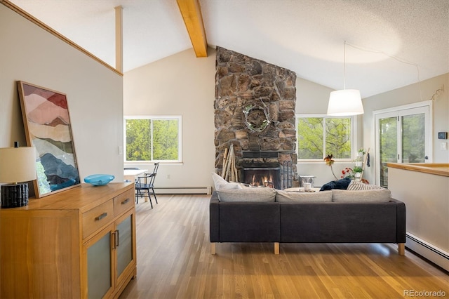 1194 Camp Eden Rd, Golden, CO 80403 - living area with a baseboard heating unit, light wood-style floors, beamed ceiling, plenty of natural light, and a fireplace