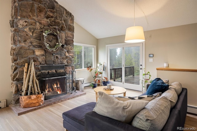 1194 Camp Eden Rd, Golden, CO 80403 - living room featuring a fireplace, wood finished floors, vaulted ceiling, a baseboard heating unit, and baseboard heating