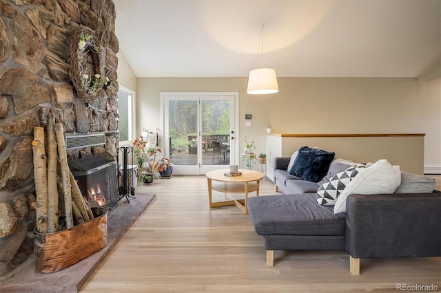 1194 Camp Eden Rd, Golden, CO 80403 - living area with wood finished floors, vaulted ceiling, and a fireplace
