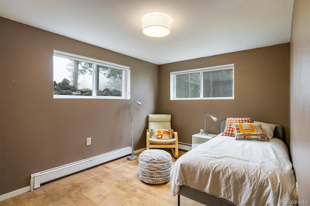 1194 Camp Eden Rd, Golden, CO 80403 - bedroom featuring a baseboard radiator, baseboards, and wood finished floors