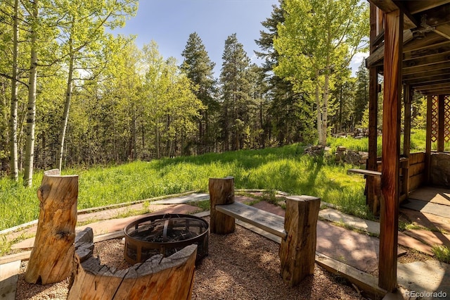 1194 Camp Eden Rd, Golden, CO 80403 - view of patio / terrace featuring an outdoor fire pit and a wooded view