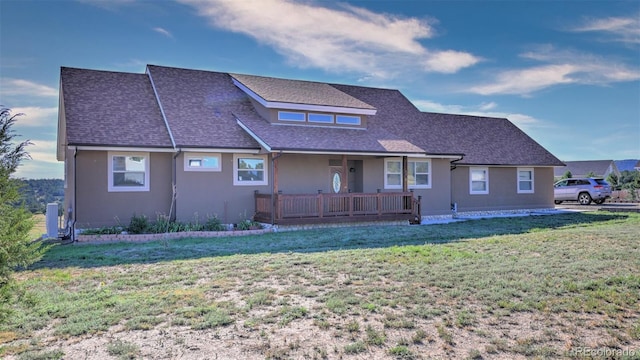 rear view of property with a lawn