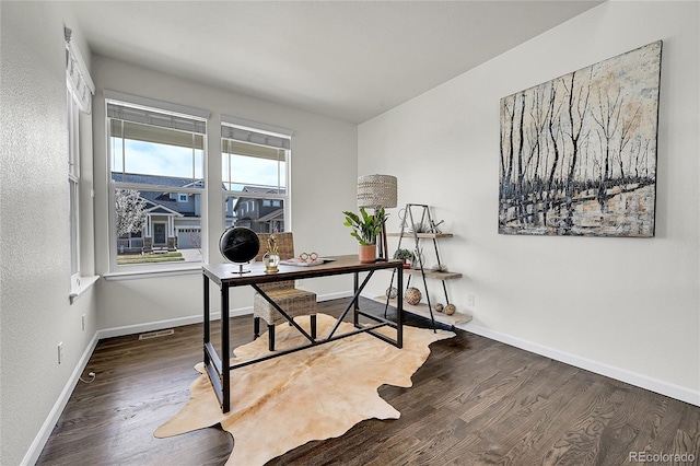 home office featuring baseboards, visible vents, and wood finished floors