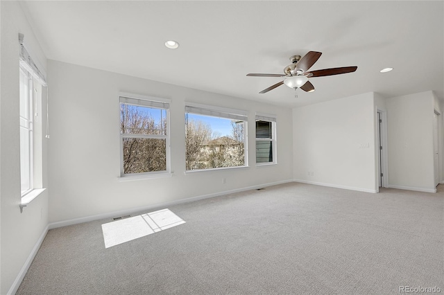 carpeted empty room featuring baseboards, visible vents, recessed lighting, and a ceiling fan