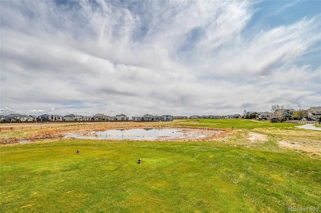 view of yard with a water view and a residential view