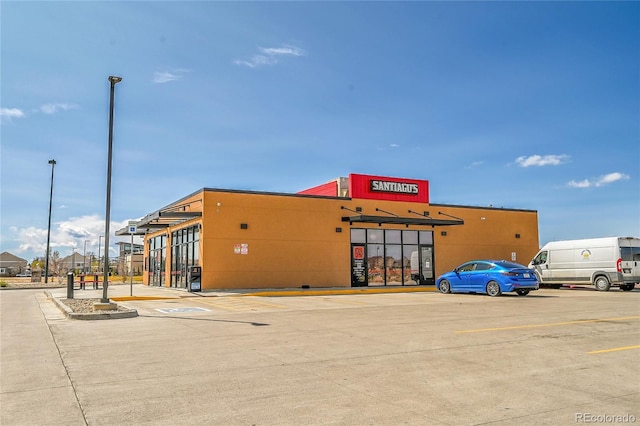 view of building exterior featuring uncovered parking