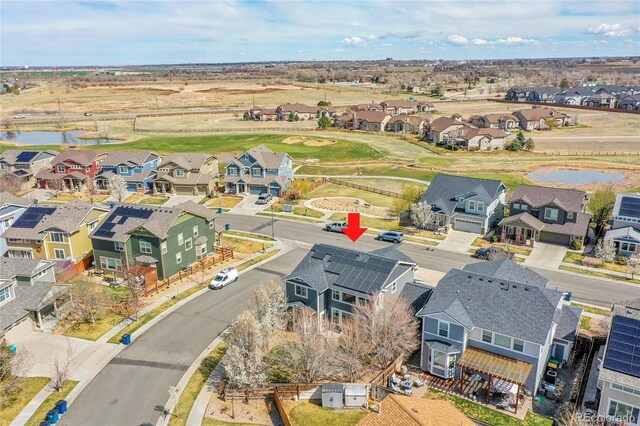 birds eye view of property with a residential view and a water view