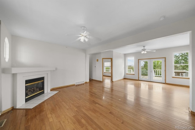 32501 E 137th Way, Brighton, CO 80603 - unfurnished living room featuring a fireplace, ceiling fan, light wood-style floors, and baseboards