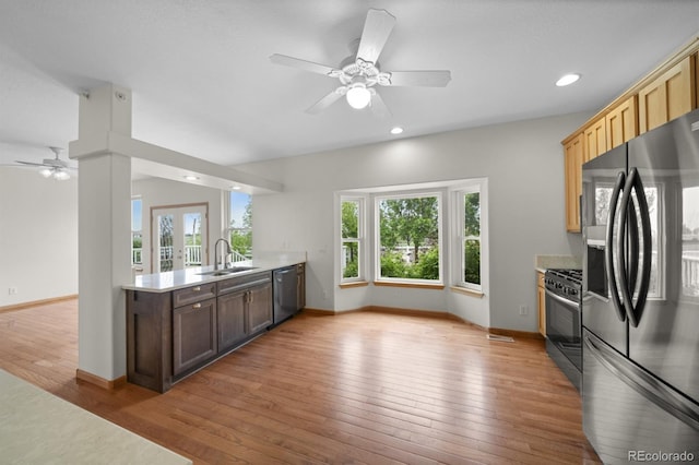 32501 E 137th Way, Brighton, CO 80603 - kitchen featuring appliances with stainless steel finishes, a ceiling fan, a sink, a peninsula, and healthy amount of natural light