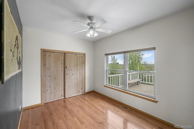 32501 E 137th Way, Brighton, CO 80603 - unfurnished bedroom featuring baseboards, light wood-style flooring, a ceiling fan, and a closet