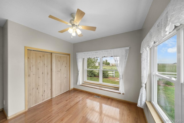32501 E 137th Way, Brighton, CO 80603 - unfurnished bedroom featuring multiple windows, light wood-type flooring, baseboards, and a closet