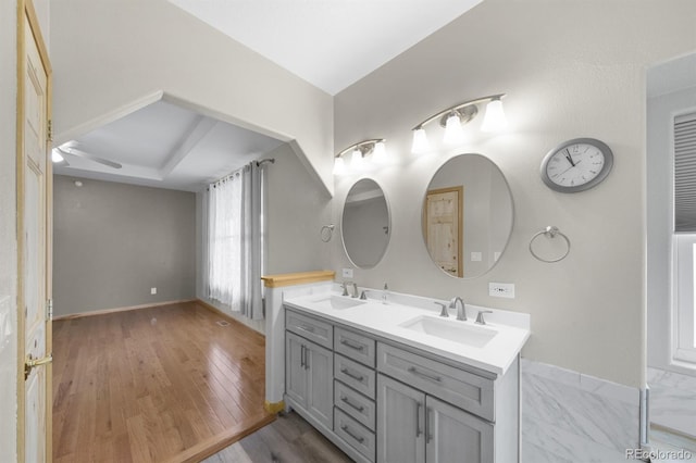 32501 E 137th Way, Brighton, CO 80603 - full bath with double vanity, ceiling fan, wood finished floors, and baseboards