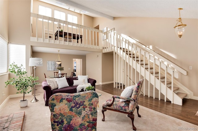 living room featuring hardwood / wood-style flooring, plenty of natural light, and high vaulted ceiling