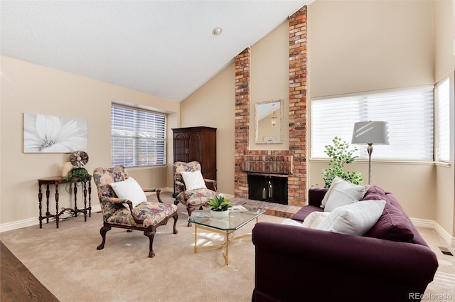 living room with light hardwood / wood-style floors, high vaulted ceiling, and a brick fireplace